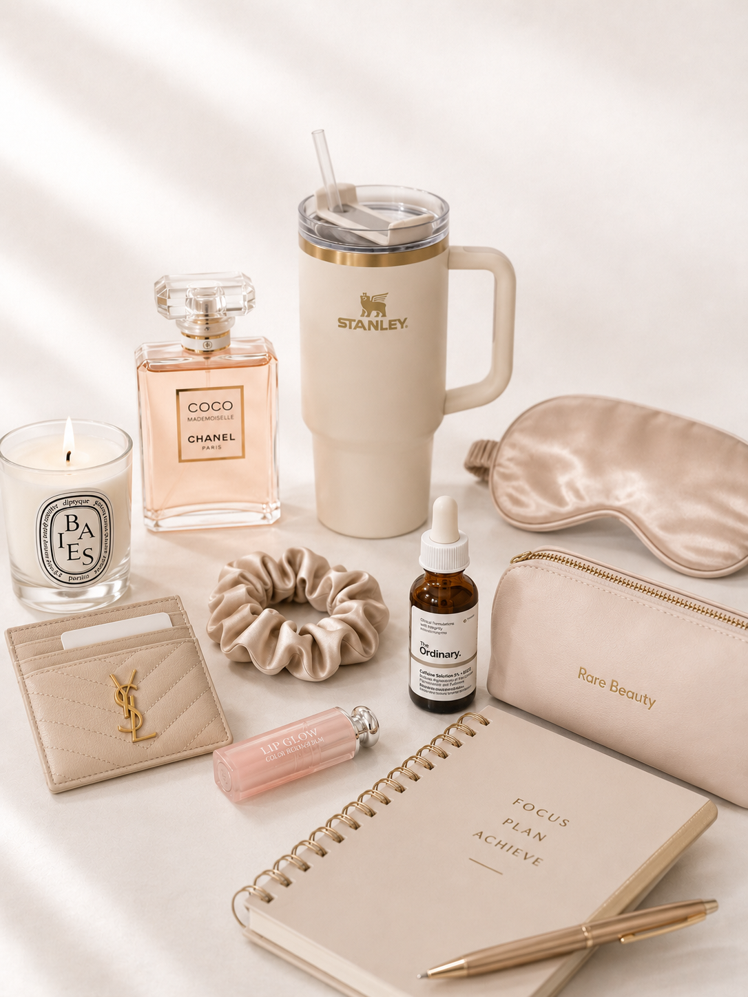 Beauty wardrobe essentials perfume, candle, silk accessories, lip glow, journal Victoria Beauty boutique.